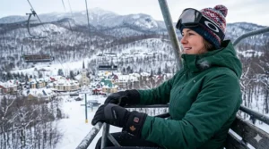 Close-up of a skier wearing high-performance heated ski gloves at a resort in Quebec, Canada.