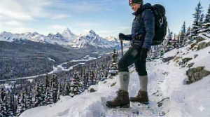 A flat-lay illustration of Canadian winter essentials including a parka, toque, and heated socks with long-lasting batteries.